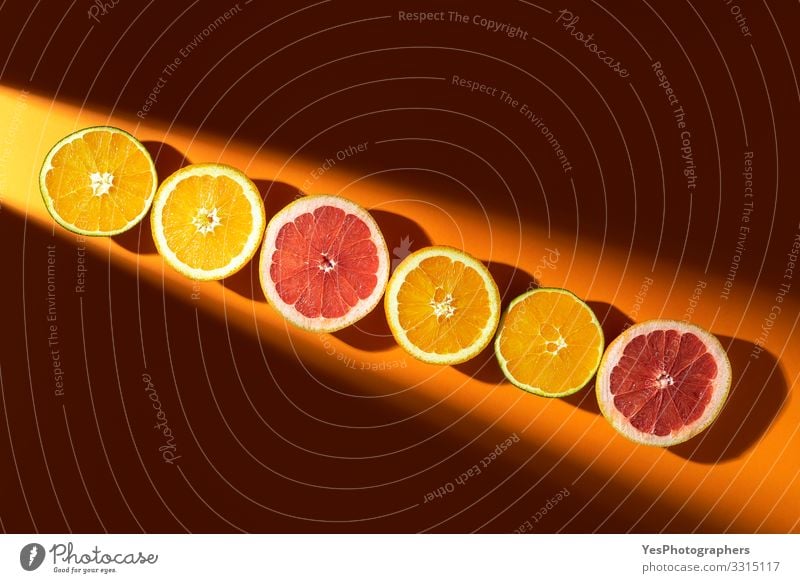 Sliced citrus fruits in sunlight. Oranges and grapefruits Fruit Organic produce Healthy Eating Summer vacation above view citrous Citrus fruits colorful