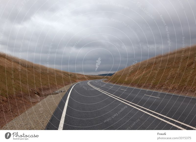 Drive | Tracks Street New Traffic infrastructure Asphalt mark lines Lane markings Traffic lane lanes Curve Construction site slope Grass Forest Sky Clouds