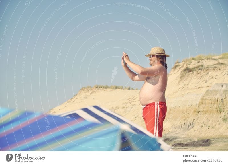 mr. k. takes a photo | man in swimming trunks stands in a dune and takes a photo Vacation & Travel Summer Sun Beach Beach dune Sand Coast Man Photographer