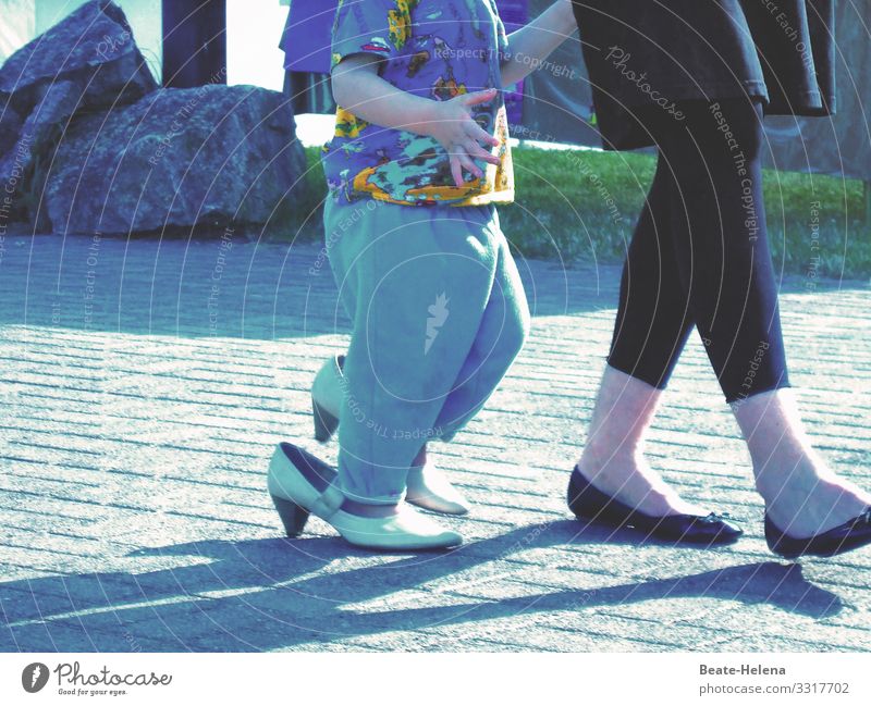 Feet of a woman and child wearing shoes that are too big foot Woman Child Adults Footwear Legs Asphalt Street High heels Exterior shot Multicoloured at large