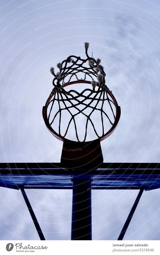 basketball hoop silhouette, street basket in Bilbao city Spain sky blue circle chain metallic net sport sports equipment play playing playful old park