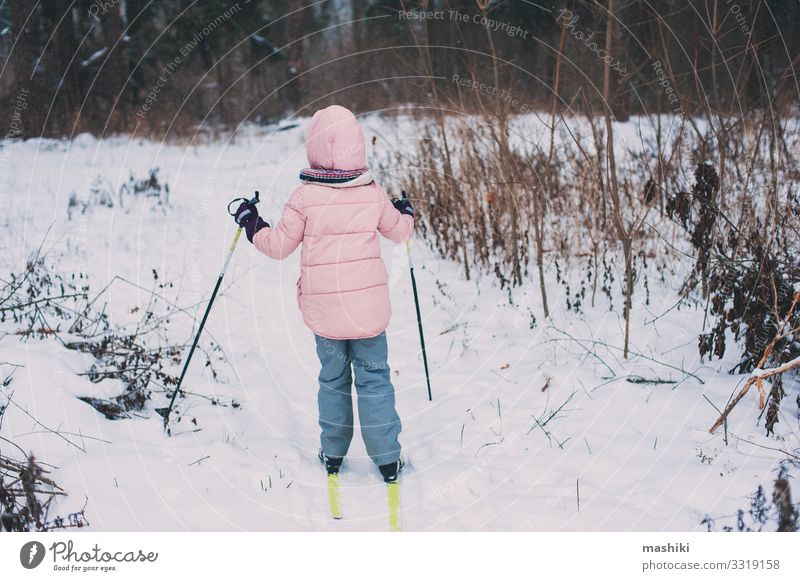 happy child girl skiing in winter snowy forest Joy Happy Relaxation Leisure and hobbies Vacation & Travel Adventure Winter Snow Sports Child