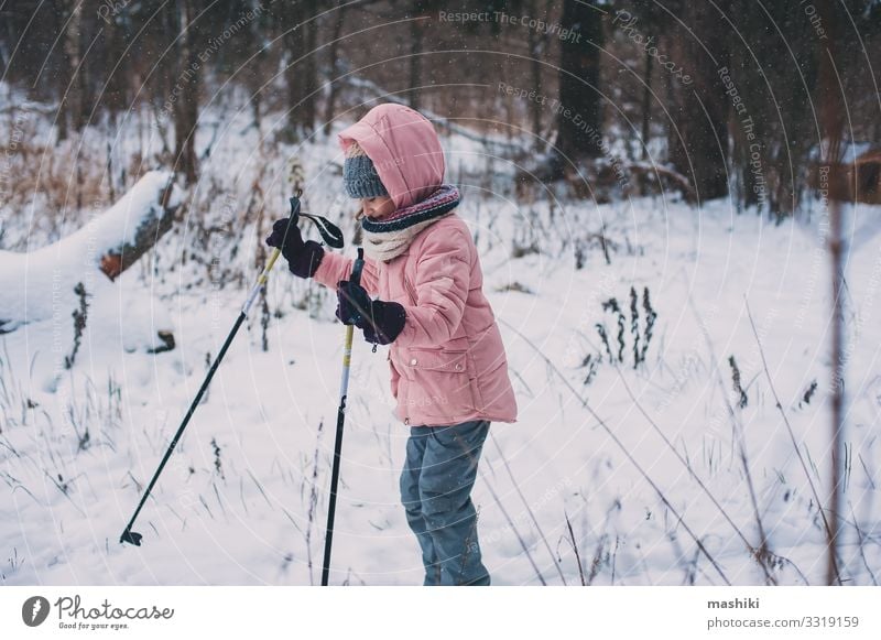 happy child girl skiing in winter snowy forest Joy Happy Relaxation Leisure and hobbies Vacation & Travel Adventure Winter Snow Sports Child