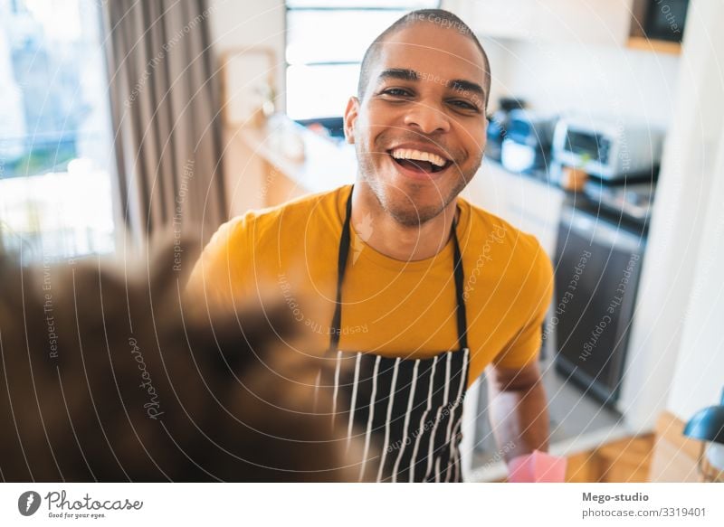 Young latin man dusting his new house. House (Residential Structure) Furniture Work and employment Man Adults Good Clean Black Housekeeping duster cleaner