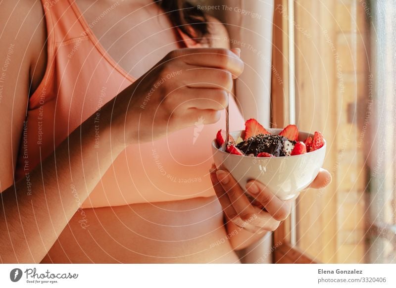 young woman with sports bra eating breakfast bowl Food Yoghurt Fruit Apple Grain Dessert Nutrition Eating Breakfast Organic produce Vegetarian diet Diet Bowl