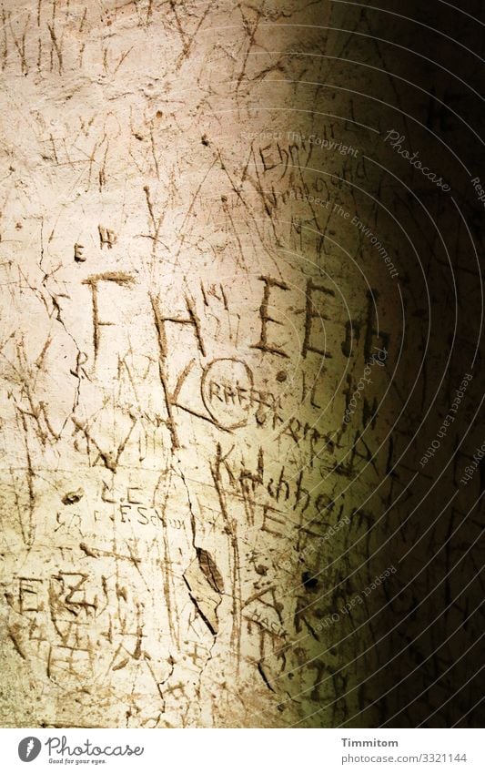 Written | in old tower Tower Wall (barrier) Wall (building) Stone Sign Characters Old Dark Brown Black Emotions Past Plaster Scratched Colour photo