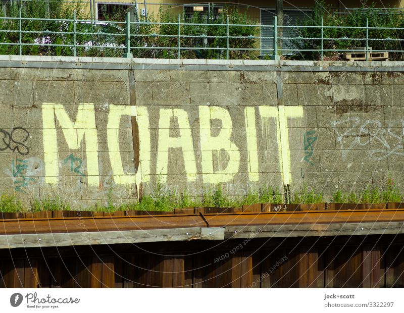 MOABIT on the Spree Street art Bank reinforcement rail Stone slab Metal Rust Characters Capital letter Authentic Large Uniqueness Creativity Symmetry