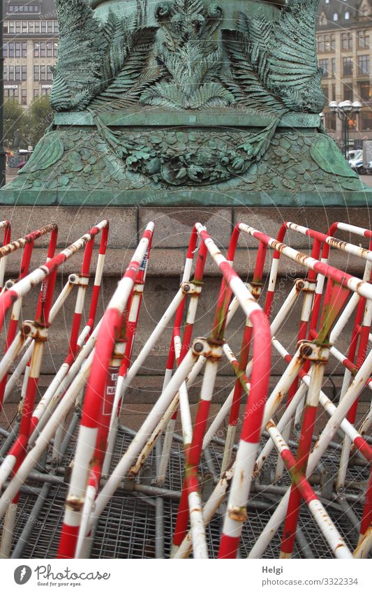 Red and white barriers in front of a monument in Hamburg Work of art Sculpture Town Barrier Signs and labeling Stand Exceptional Gray Turquoise White Safety