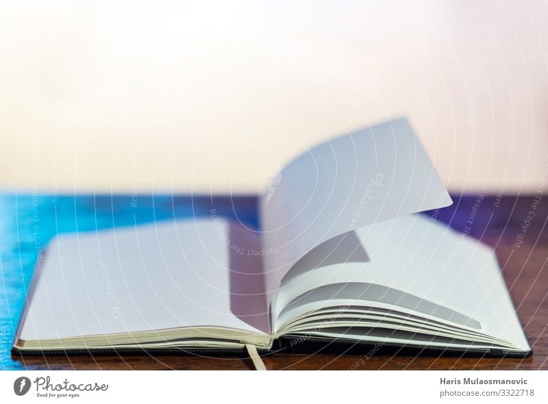 Empty book on the desk with blurry background Notebook Society Idea Trade Planning School Writing Paper Booklet Old Colour photo Interior shot Studio shot