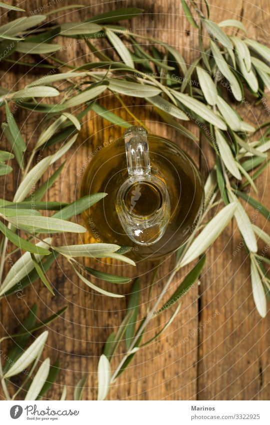 Virgin olive oil glass jar and leaves on wooden table. Eating Vegetarian diet Diet Bottle Nature Plant Tree Leaf Fresh Natural Green background branch food