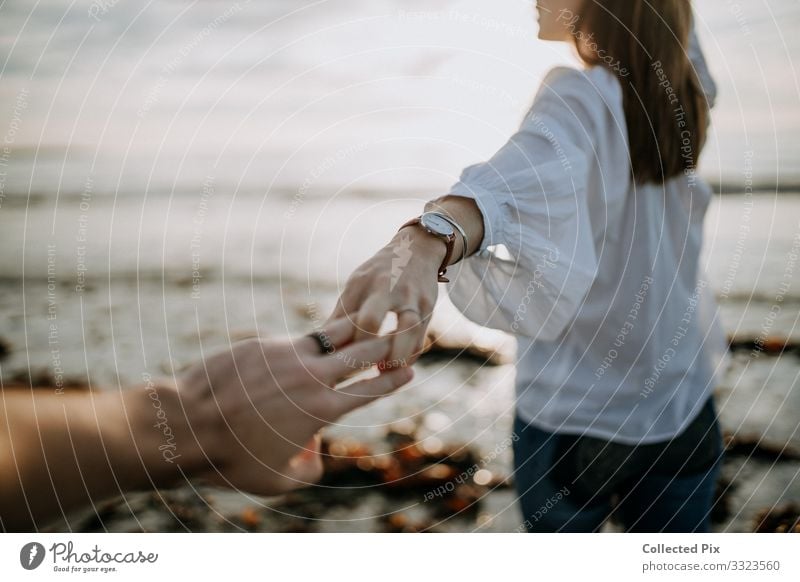 Woman looking back holding man's hand on beach Lifestyle Luxury Well-being Vacation & Travel Trip Adventure Freedom Ocean Feasts & Celebrations Valentine's Day