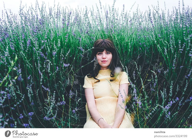 Young brunette woman sitting surrounded by lavender Lifestyle Beautiful Relaxation Calm Freedom Summer Human being Feminine Young woman Youth (Young adults)