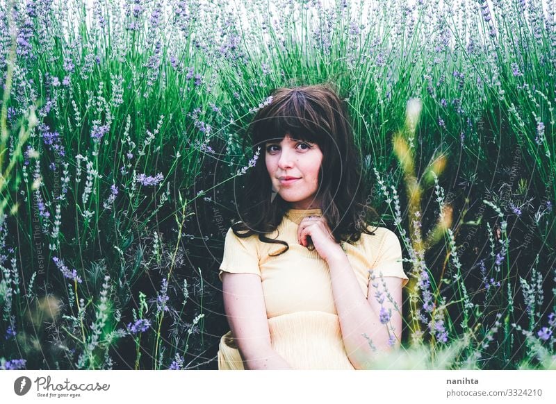 Young brunette woman sitting surrounded by lavender young pretty retro vintage nature natural real candid relax tranquility scene flowers spring springtime