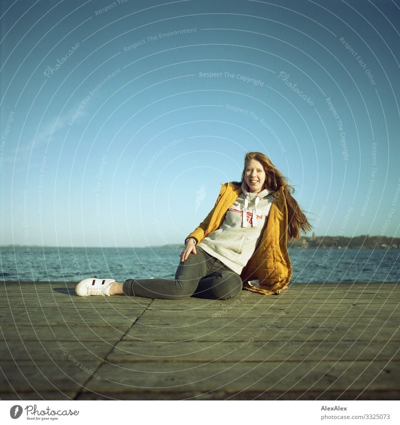 Young woman on a jetty at the Baltic Sea Lifestyle Joy Beautiful Well-being Trip Ocean Youth (Young adults) 18 - 30 years Adults Landscape Water Cloudless sky