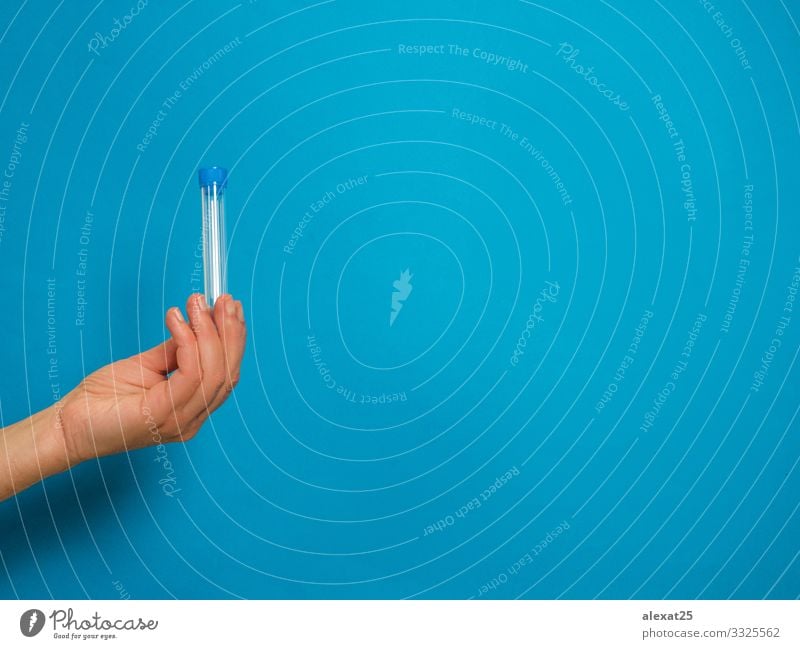 Hand with analysis tube on blue background with copy space Bottle Health care Illness Medication Science & Research Laboratory Examinations and Tests Container