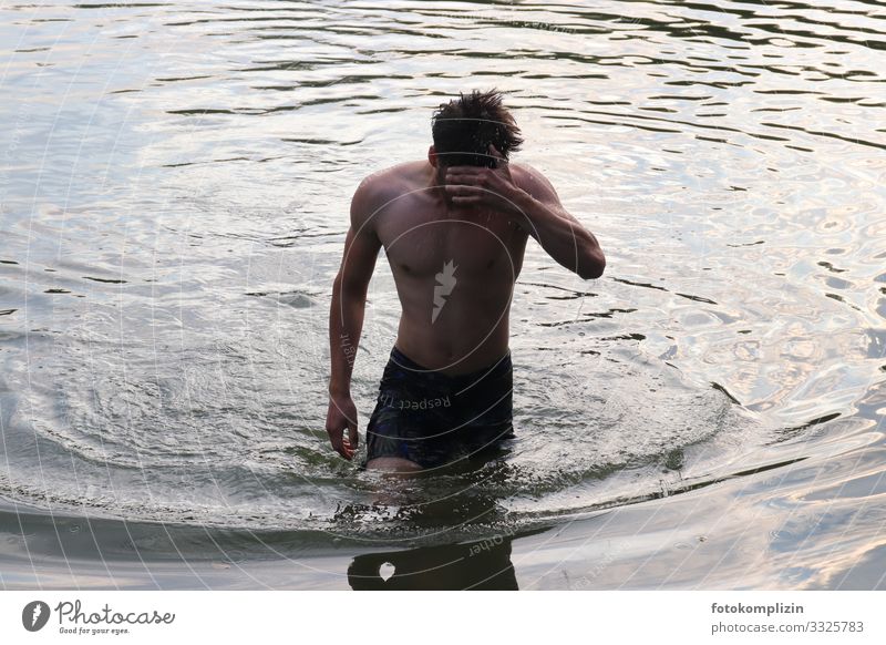 young man comes out of the water after swimming Healthy Fitness Masculine Young man Youth (Young adults) 1 Human being 18 - 30 years Adults Water Waves