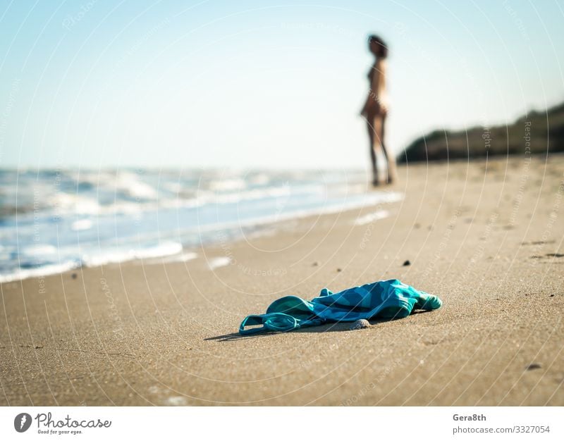 swimsuit on the beach on the background of a naked female figure Summer Beach Ocean Waves Young woman Youth (Young adults) Nature Sand Sky Horizon Warmth Coast