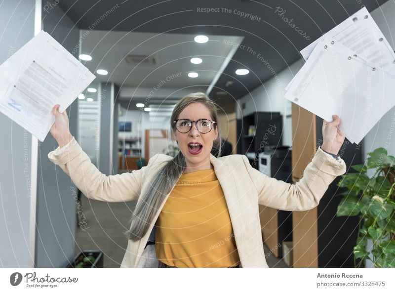 Stressed woman throws papers in the office in an image of relief Relaxation Vacation & Travel Work and employment Profession Workplace Office Business