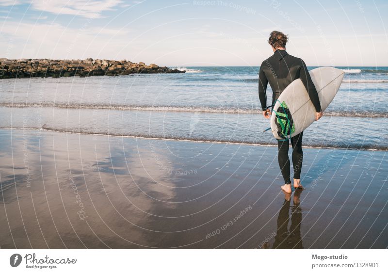 Surfer entering into the water with his surfboard. Lifestyle Joy Relaxation Adventure Beach Ocean Waves Sports Aquatics Human being Masculine Man Adults 1