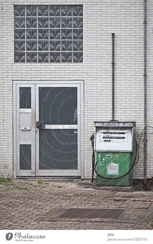 SUPER Town Industrial plant Factory Manmade structures Building Wall (barrier) Wall (building) Facade Window Door Gloomy Petrol pump Petrol station Colour photo