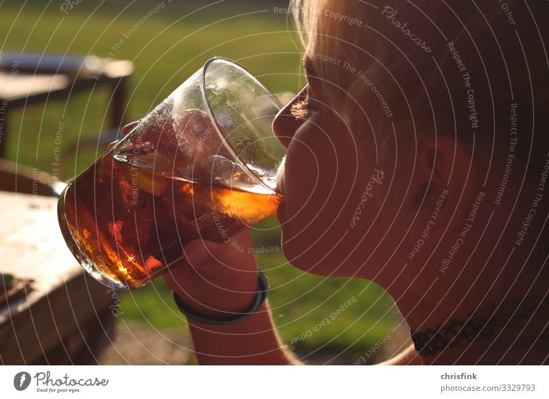 Girl drinking from glass in the evening sun Beverage Drinking Cold drink Juice Longdrink Cocktail Glass Human being Child Head 8 - 13 years Infancy Sign