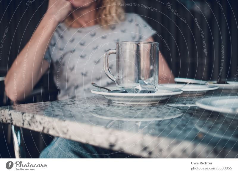 Fau at a table behind an empty teacup To have a coffee Tea Cup Glass Spoon Contentment To enjoy Colour photo Exterior shot Day Shallow depth of field