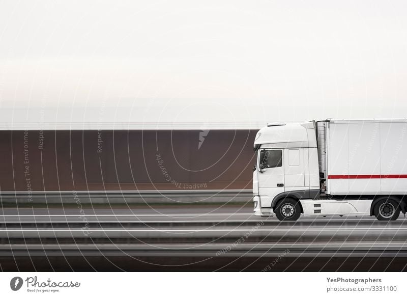 White truck moving on a highway. Truck panning. Selective focus Logistics Transport Road traffic Street Highway Vehicle Container Driving Speed Loneliness