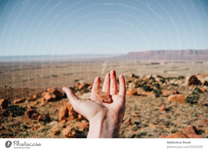 Faceless man with stone in hand in desert explore dune sky dry usa travel panorama journey male day vacation nature summer state guy america landscape resort