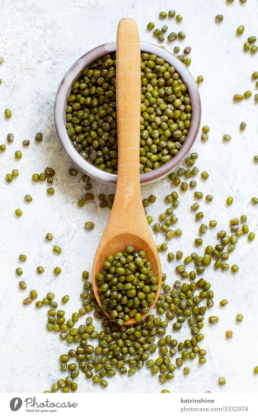 Dried mung beans in a bowl with a wooden spoon Vegetarian diet Diet Bowl Spoon Table Above Green White Beans fiber food health healthy Ingredients Kidney legume