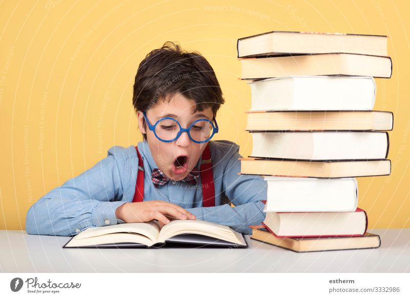 surprised boy reading a book Lifestyle Reading Child School Study Schoolchild Student University & College student Human being Masculine Boy (child) Infancy 1