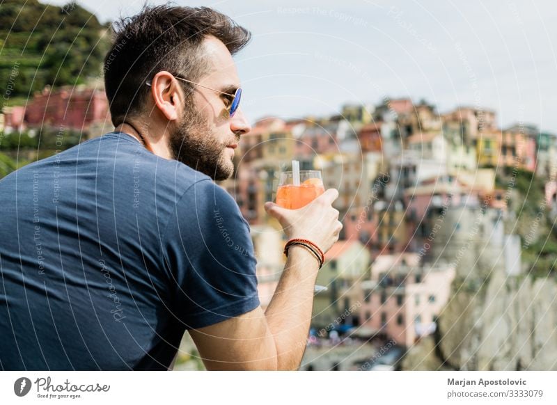 Young man drinking cocktail in village of Cinque Terre Drinking Juice Alcoholic drinks Longdrink Cocktail Lifestyle Joy Vacation & Travel Tourism Trip