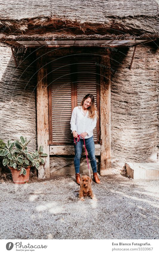 young woman and her cute puppy of cocker spaniel outdoors Woman Dog Pet Park Sunbeam Exterior shot Love Embrace Smiling Rear view Kissing Breed Purebred