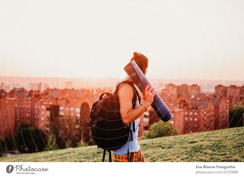 young man in a park ready to practice yoga sport. city background. healthy lifestyle Concentrate Position Human being Youth (Young adults) Body Park Man