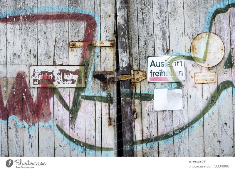 Door and gate (2) Old Exterior shot Day Colour photo Old town Wooden door Lock Locking bar Closed Detail locked Subdued colour Derelict Portrait format Goal