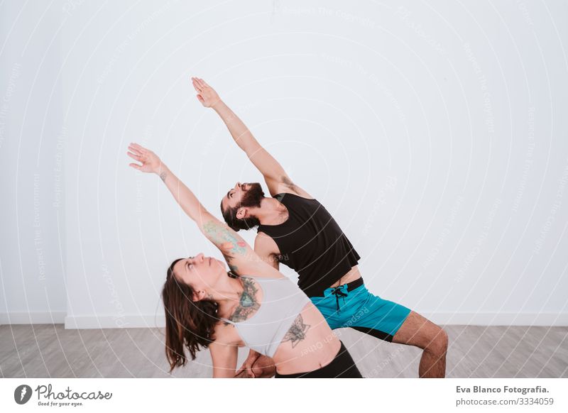 young man and woman practicing yoga sport at the gym. Healthy lifestyle Yoga Man Boy (child) Sports Lifestyle Interior shot Gymnasium Studio shot White hispanic