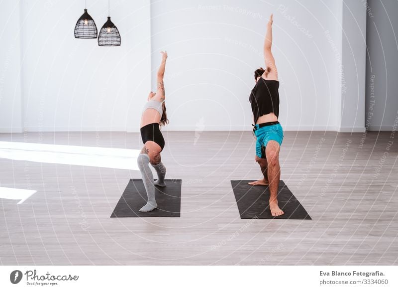 young man and woman practicing yoga sport at the gym. Healthy lifestyle Yoga Man Boy (child) Sports Lifestyle Interior shot Gymnasium Studio shot White hispanic