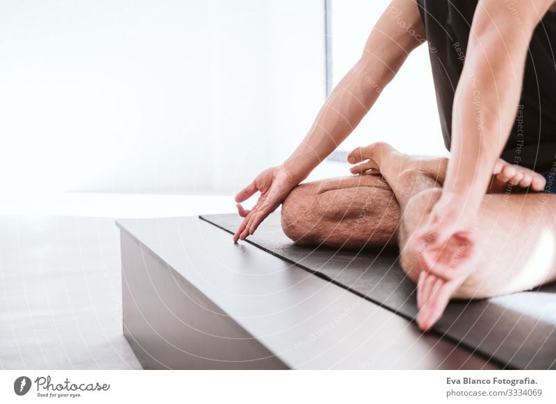 young man practicing yoga sport at the gym. Healthy lifestyle. close up view Yoga Man Boy (child) Sports Lifestyle Interior shot Gymnasium Studio shot White