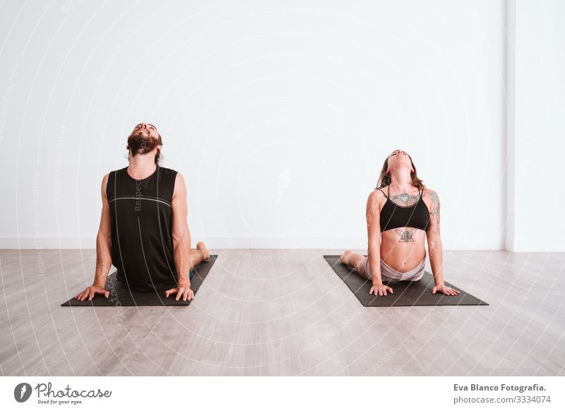 young man and woman practicing yoga sport at the gym. Healthy lifestyle Yoga Man Boy (child) Sports Lifestyle Interior shot Gymnasium Studio shot White hispanic