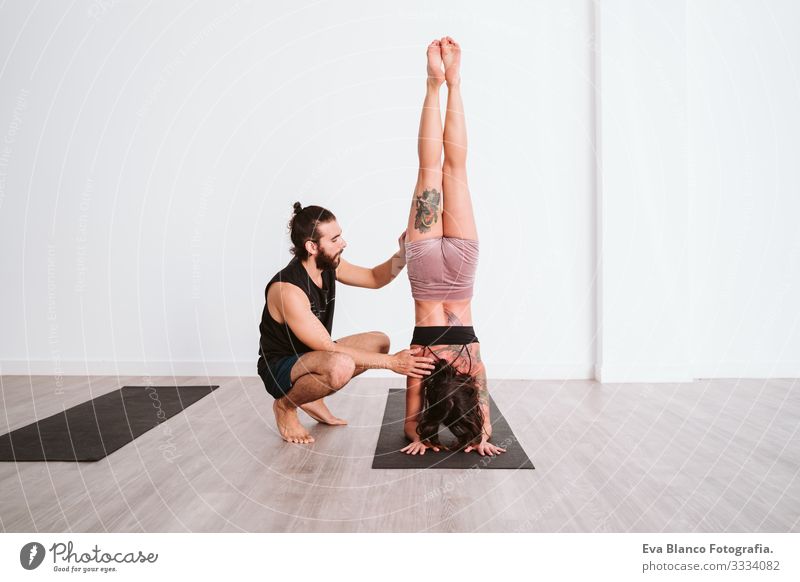 young man and woman practicing yoga sport at the gym. Healthy lifestyle Yoga Man Boy (child) Sports Lifestyle Interior shot Gymnasium Studio shot White hispanic