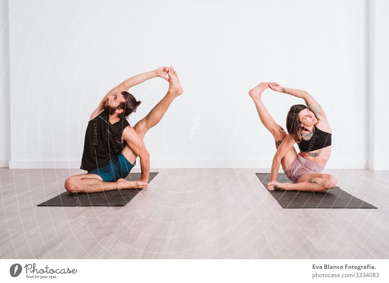 young man and woman practicing yoga sport at the gym. Healthy lifestyle Yoga Man Boy (child) Sports Lifestyle Interior shot Gymnasium Studio shot White hispanic