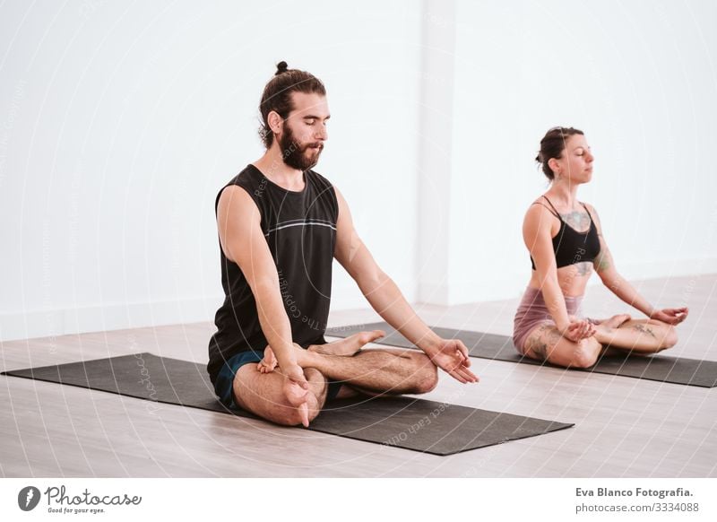 young man and woman practicing yoga sport at the gym. Healthy lifestyle Yoga Man Boy (child) Sports Lifestyle Interior shot Gymnasium Studio shot White hispanic