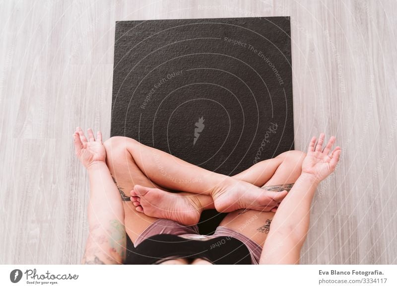 young tattooed woman practicing yoga sport at the gym. Healthy lifestyle. top view Woman Youth (Young adults) tattoed Yoga Sports Lifestyle Interior shot