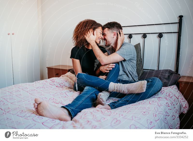 happy couple in love at home. Afro american woman and caucasian man. ethnic love concept Couple Love African-American Ethnic Woman Home Bed Interior shot