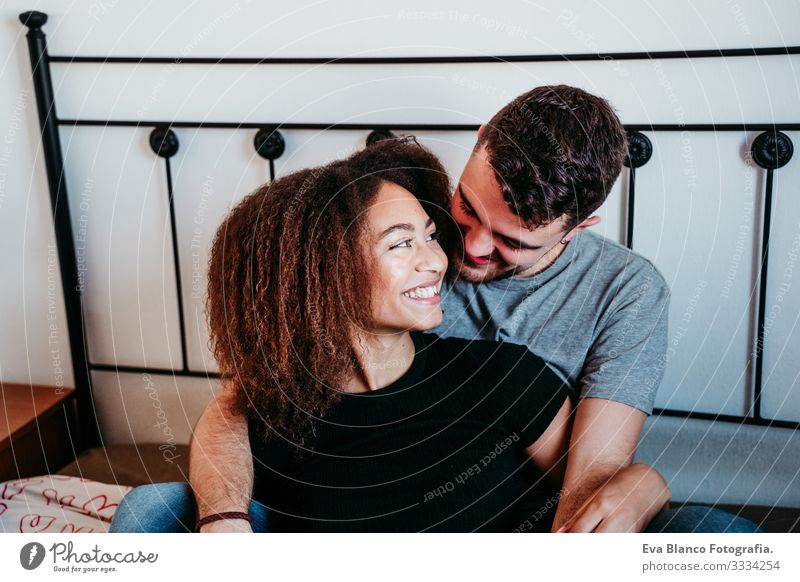 happy couple in love at home. Afro american woman and caucasian man. ethnic love concept Couple Love African-American Ethnic Woman Home Bed Interior shot