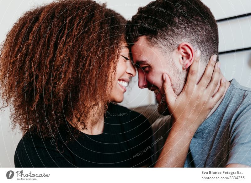 happy couple in love at home. Afro american woman and caucasian man. ethnic love concept Couple Love African-American Ethnic Woman Home Bed Interior shot