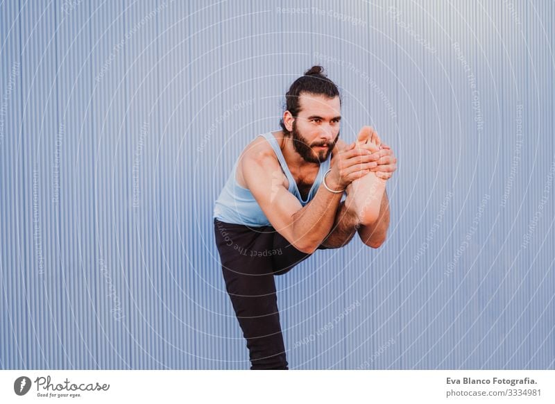 man in the city practicing yoga sport. blue background. healthy lifestyle Yoga Man Sports Healthy Exterior shot City Blue background Muscular