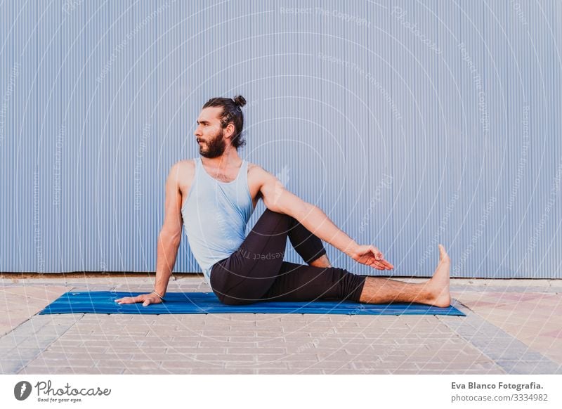 man in the city practicing yoga sport. blue background. healthy lifestyle Yoga Man Sports Healthy Exterior shot City Blue background Muscular