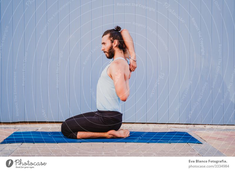 man in the city practicing yoga sport. blue background. healthy lifestyle Yoga Man Sports Healthy Exterior shot City Blue background Muscular