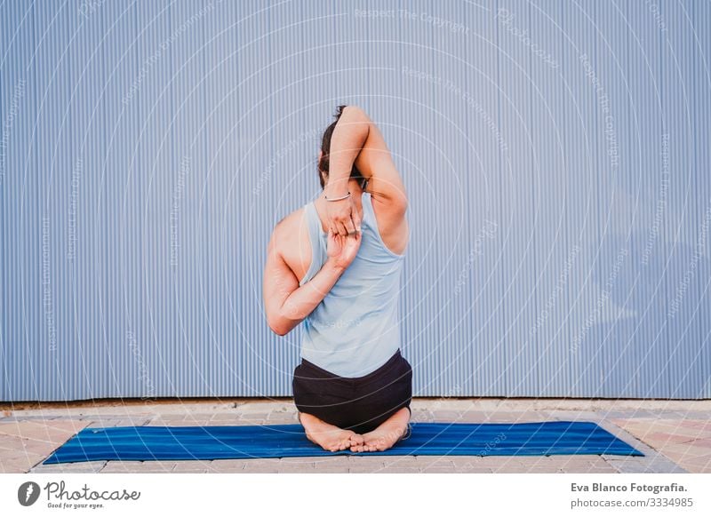 man in the city practicing yoga sport. blue background. healthy lifestyle Yoga Man Sports Healthy Exterior shot City Blue background Muscular