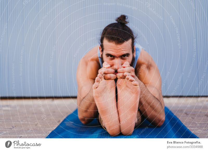 man in the city practicing yoga sport. blue background. healthy lifestyle Yoga Man Sports Healthy Exterior shot City Blue background Muscular